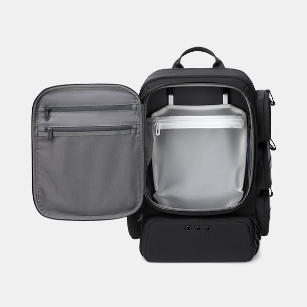 Black backpack with open front pocket showing gray interior on a light gray background