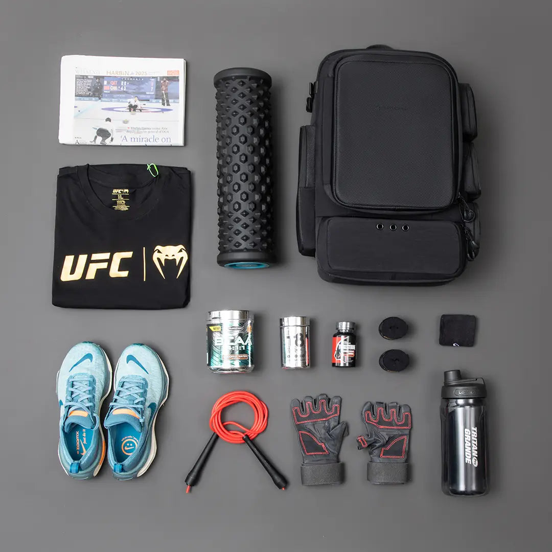 Cinomadist gym backpack flat lay with running shoes, foam roller and training gear