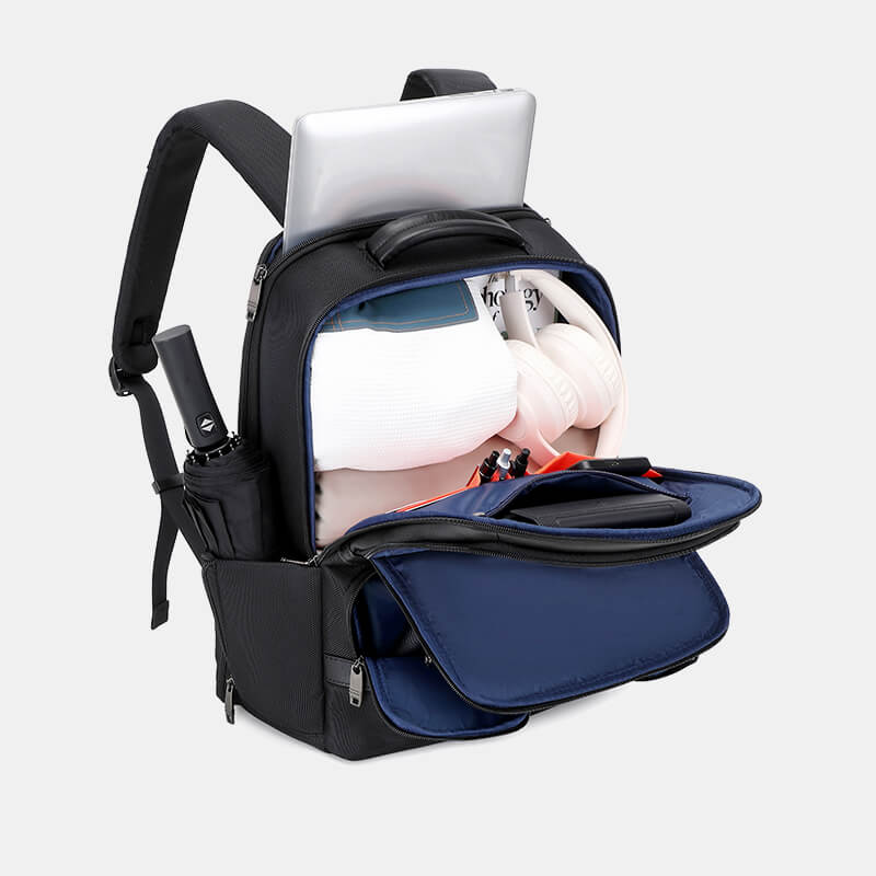 Black backpack with open compartment showing laptop, tablet, and other items on a light gray background