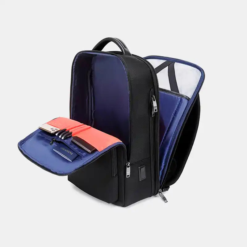 Black and blue backpack with open compartments on a light gray background