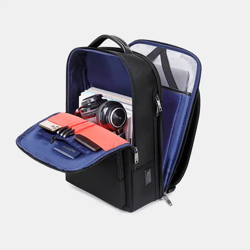 Black and blue backpack with open compartment showing items on a light gray background