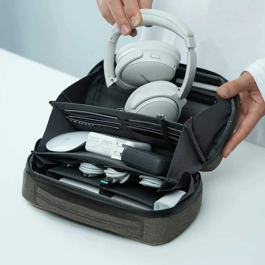Tech organizer pouch by Cinomadist storing headphones, cables, and other tech essentials for travel.
