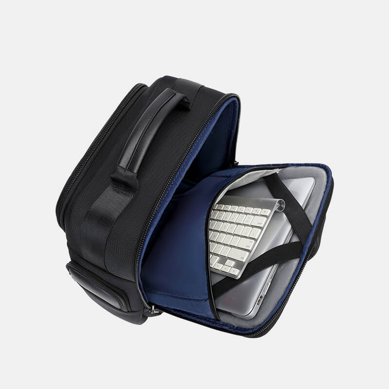 Black and blue backpack with a laptop compartment on a light gray background