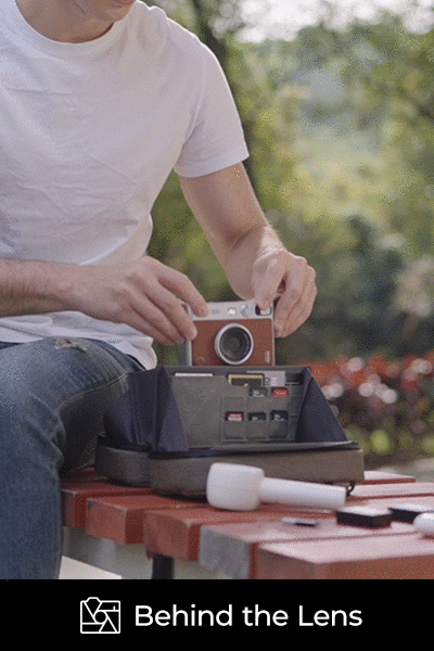 A person taking a camera out of the TechPouch digital organizer.