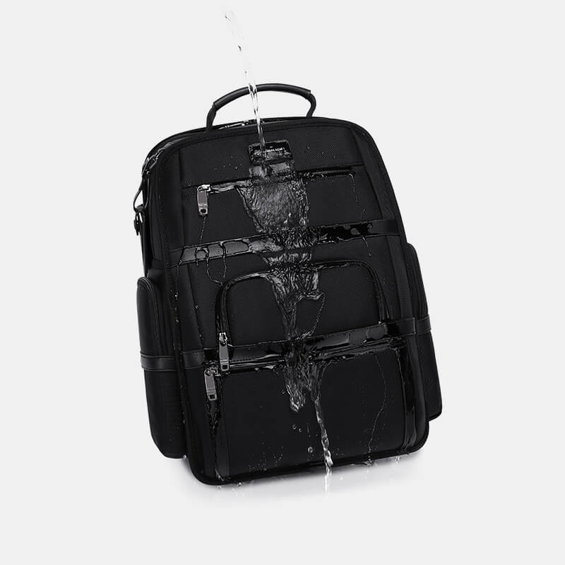 Black backpack with water splashes on a white background