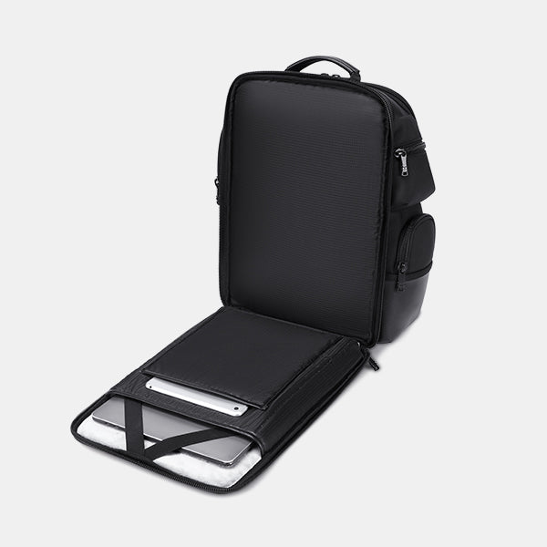 Black backpack with a laptop compartment on a light gray background