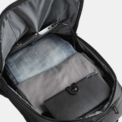 Open suitcase with gray interior and clothing items on a white background