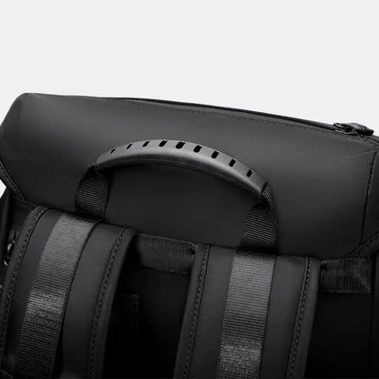 Close-up of a black backpack with straps on a white background
