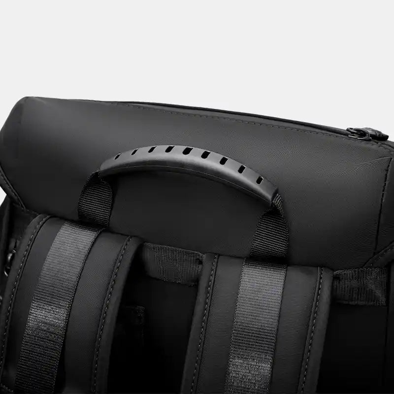 Close-up of a black backpack with straps on a white background
