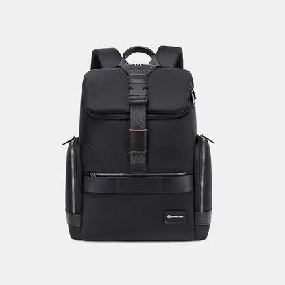 Black backpack with multiple compartments on a light gray background
