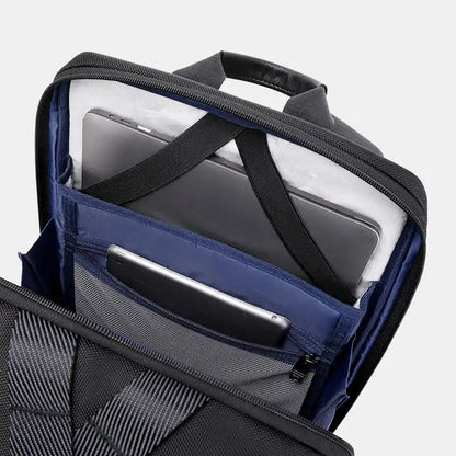 Everyday Backpack with compartments for a laptop and phone on a light gray background