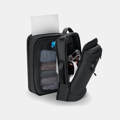 Open-view demonstration of the Travel Expandable Backpack Pro highlighting its dedicated laptop sleeve, front tech compartment, and structured clothing partition.