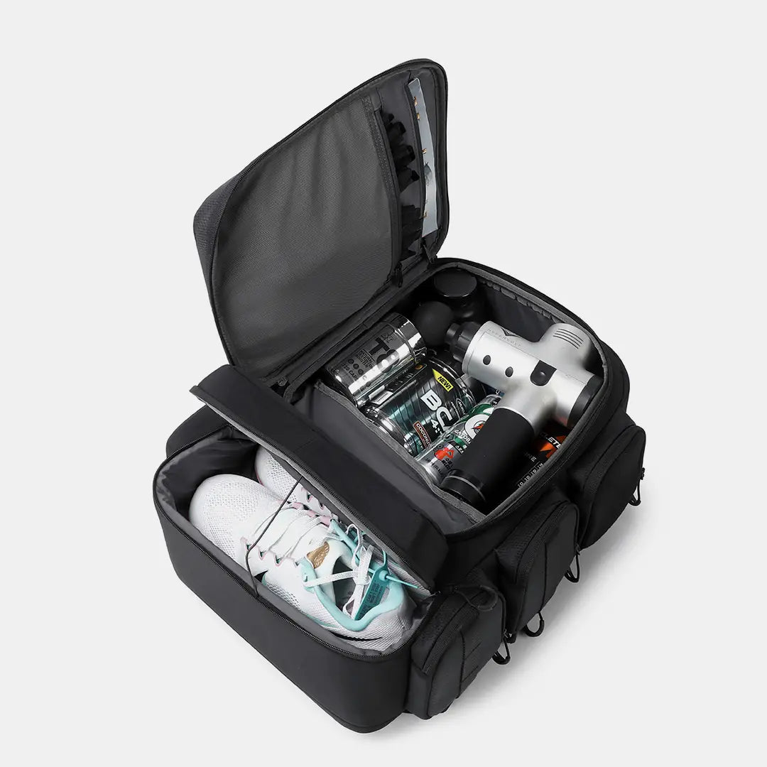 Training backpack bottom shoe compartment separating sneakers from supplements and massage gun