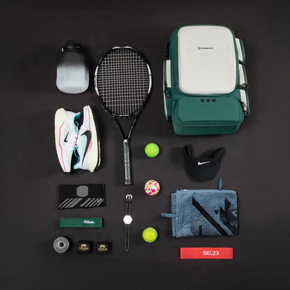Green Cinomadist gym backpack flat lay with tennis racket, running shoes and training accessories