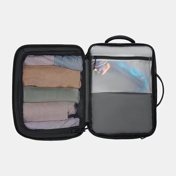 Interior of backpack showing neatly packed clothes in dual mesh compartments for travel organization.