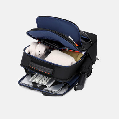 Black backpack with compartments containing a laptop, keyboard, and other items on a white background