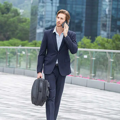 Man carrying the Cinomadist backpack in briefcase style while walking outdoors