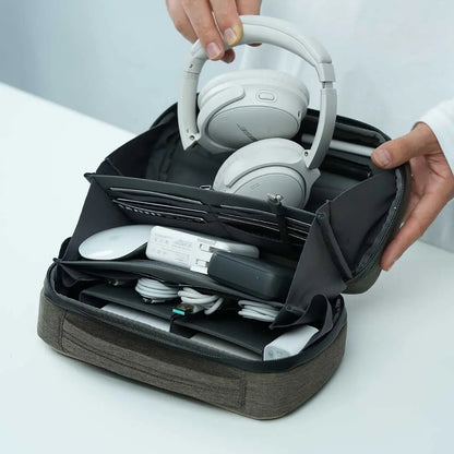 Tech organizer pouch by Cinomadist storing headphones, cables, and other tech essentials for travel.