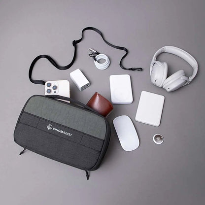 Cinomadist tech pouch with neatly organized tech accessories like cables, charger, headphones, and mouse.