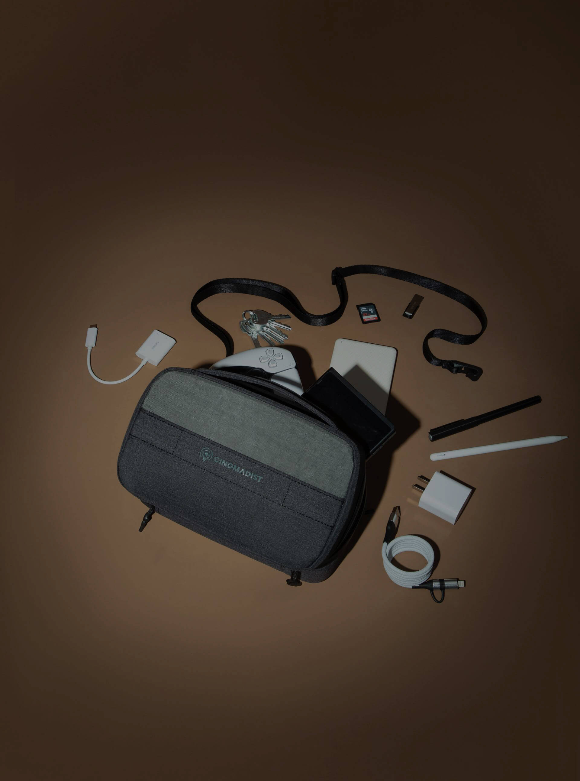A digital organizer bag and its neatly arranged contents displayed on a table.