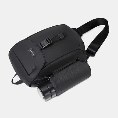 Black sling with a cylindrical black bag on a light gray background