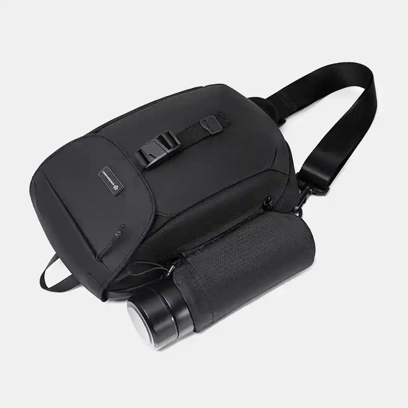 Black sling with a cylindrical black bag on a light gray background