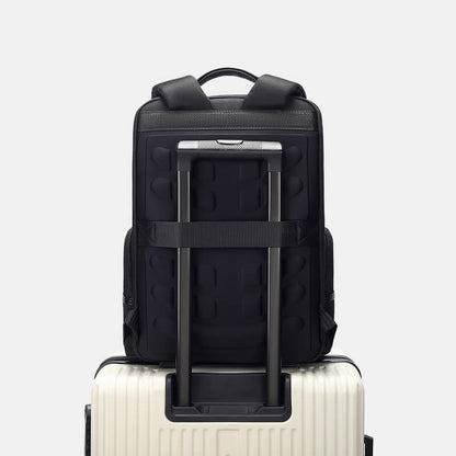 Black backpack with a suitcase on a light gray background