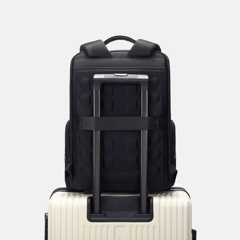 Black backpack with a suitcase on a light gray background