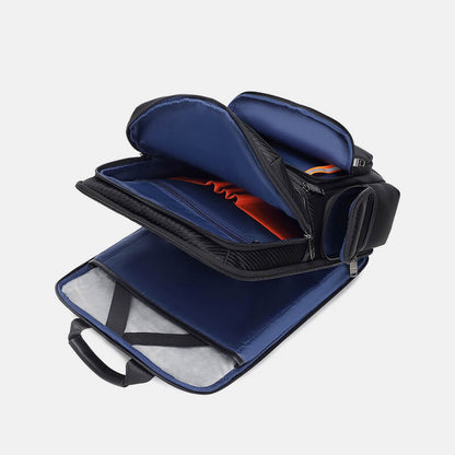 Blue and black travel bag with open compartments on a light gray background