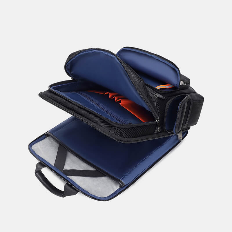 Blue and black travel bag with open compartments on a light gray background