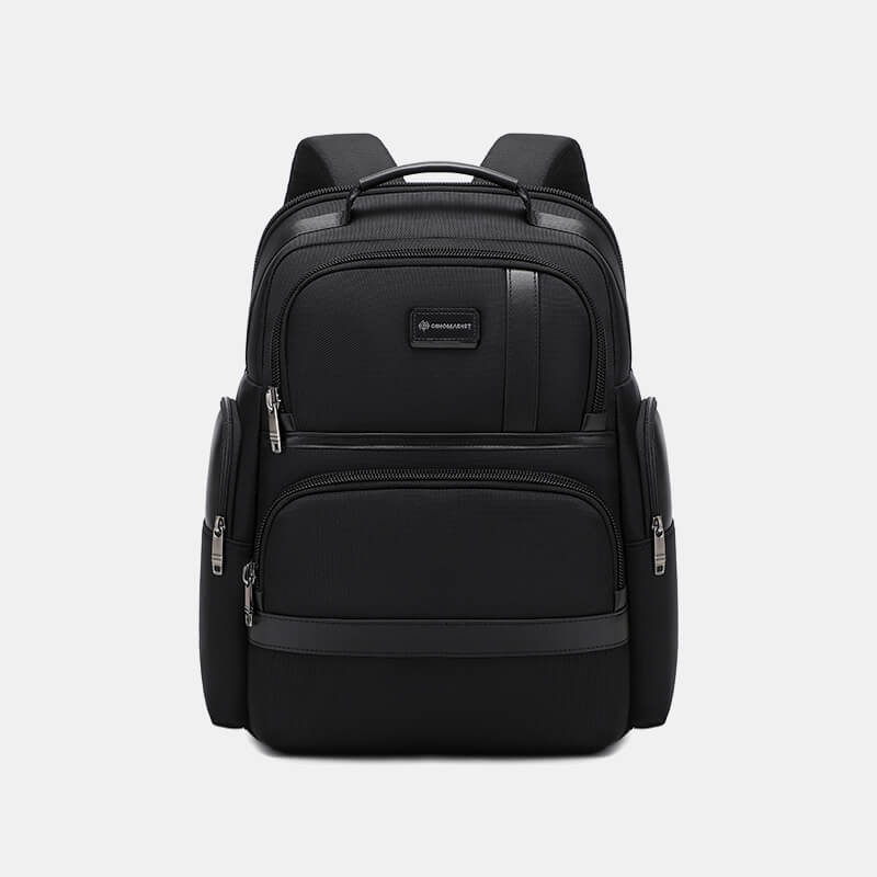 Black backpack with multiple pockets and zippers on a light gray background