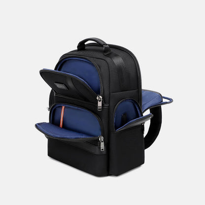 Black backpack with blue interior compartments on a light gray background
