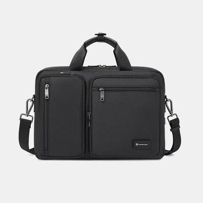 Black travel bag with multiple compartments on a light gray background