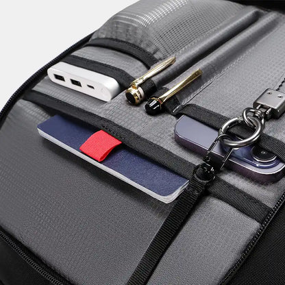 Black backpack with multiple compartments and items inside