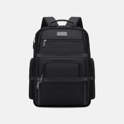 Black backpack with multiple compartments on a light gray background