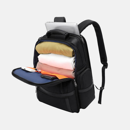 Black backpack with compartments containing items on a light gray background