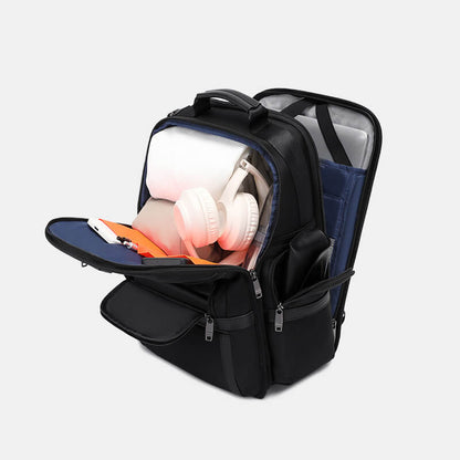 Black backpack with compartments containing electronic devices on a light gray background