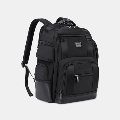 Black backpack with multiple pockets on a light gray background