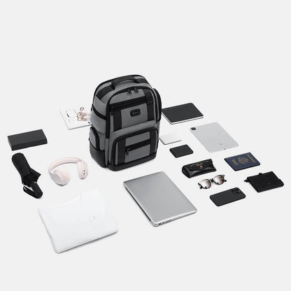 Backpack with various electronic devices and accessories on a white background