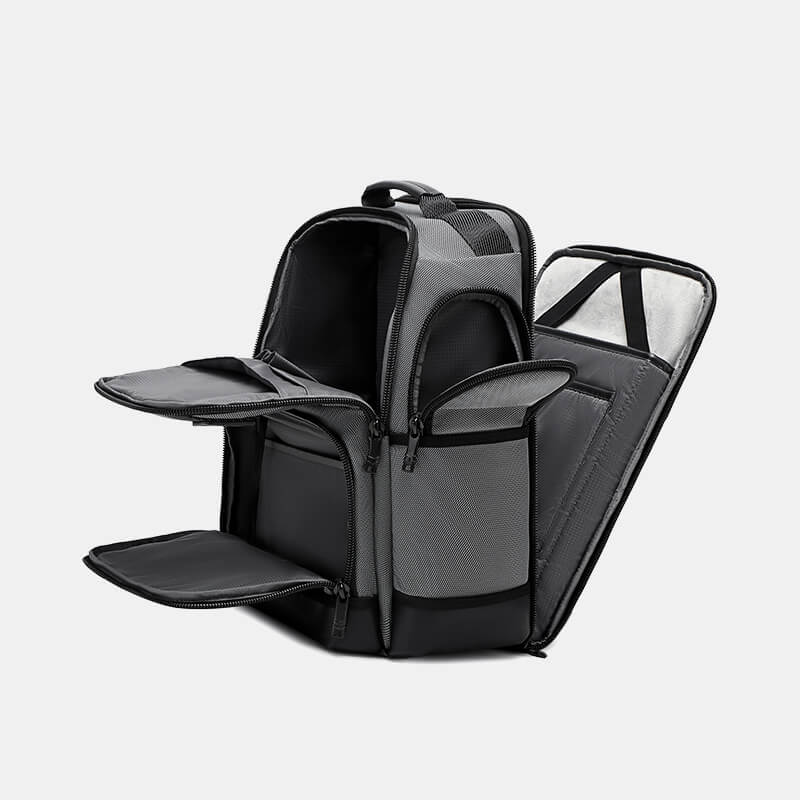 Black backpack with multiple compartments on a light gray background